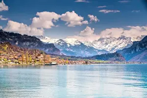 Bern Prints: Brienz town on lake Brienz by Interlaken with the Swiss Alps covered by snow in the background