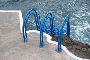 Bright Blue Prints: Bright blue ladder leads into the churning ocean waters at Porto Moniz natural pools