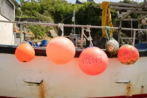Buoy Prints: Bright red buoys on traditional fishing boat on the beach of the small fishing village of Cadgwith