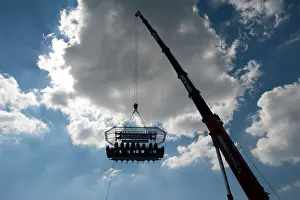 Pop Up Prints: A British Airways high-flying dining table dangling from a crane with 22 diners 100 foot high in the sky above Brighton
