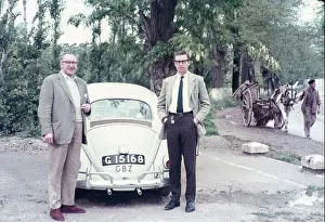Donkey Prints: Two British men stand by Volkswagen VW Beetle car with Gibraltar registration plate GBZ in Spain captioned as on road
