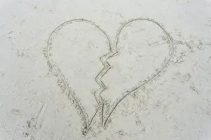 Sand Sea Prints: broken heart drawn on sand at beach