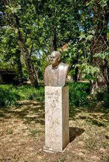 Green Space Prints: Bronze bust of Winston Churchill on stone pedestal surrounded by trees in City Park
