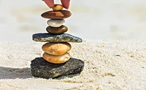 Rest Prints: Brown and white stones are on a beach
