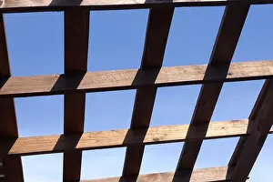 Shed Prints: Top of a brown wooden gazebo on a sunny summer day bottom up view outdoors