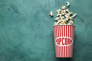 Junk Prints: Bucket with tasty popcorn on green background