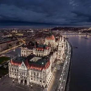 Parliament Building Prints: Budapes, Hungary - Aerial drone view of the beautiful illuminated Parliament of Hungary at blue hour with Szechenyi