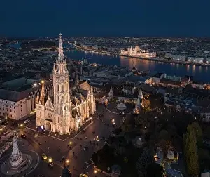 Fishermans Prints: Budapest, Hungary - Aerial drone view of the beautiful illuminated Matthias Church at blue hour with Fisherman's