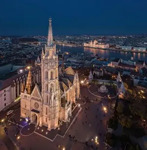 Fishermans Prints: Budapest, Hungary - Aerial drone view of the beautiful illuminated Matthias Church at blue hour with Fisherman's