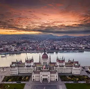 Golden Green Prints: Budapest, Hungary - Aerial drone view of the beautiful Parliament of Hungary with a dramatic colorful sunset
