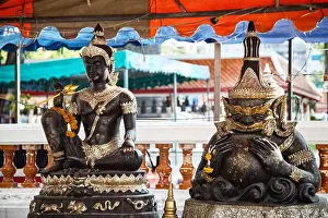 Zodiac Prints: Buddha and Rahu sculptures at Buddhist shrine in Thailand
