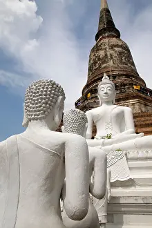 Chedi Prints: Buddha statues in Ayutthaya Thailand under a blue sky with fluffy white clouds