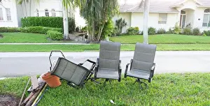 Dump Prints: Bulk trash including discarded chairs at curbside for garbage collection