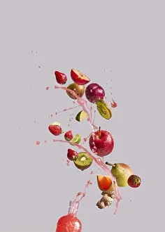 Grapefruit Prints: Bunch of various fresh fruits and ginger falling into glass bottle with healthy juice against gray background