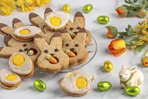 Variegated Prints: Bunny biscuits and egg biscuits decorated with icing next to Easter eggs and spring flowers
