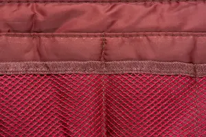 Handbag Prints: Burgundy travel bag organizer with pockets from mesh fabric, close-up