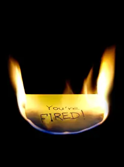 Trouble Prints: Burning post it note sticker sticky notes reminder message on black You are fired Pink Slip Business concept isolated
