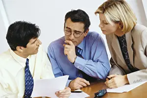 Explaining Prints: Business colleagues studying document