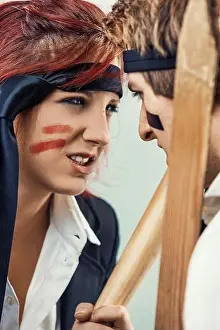 Threat Prints: Two business people fiercely argue with wooden weapons and war paint