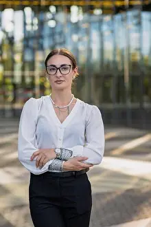Businesswoman Prints: A business professional stands outside a modern building in the city