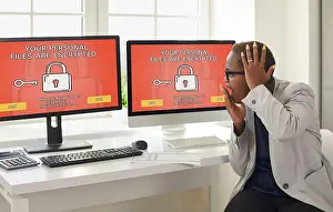 Threat Prints: Business woman gets stress from seeing a sign on computers that her personal files are encrypted