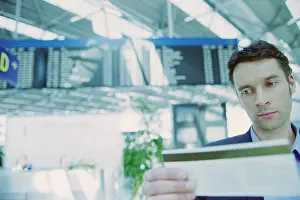 Office Worker Prints: Businessman checking airline ticket