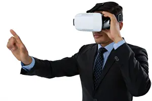 Kneeling Prints: Businessman gesturing while using vr glasses against white background