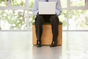 Knees Prints: Businessman with a laptop resting on his knees Cape Town Western Cape Province South Africa
