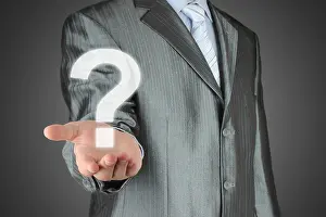 Confusion Prints: Businessman with question mark on dark background