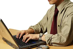 Business Person Prints: A businessman working on his laptop at the office