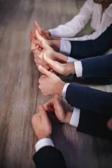 Coworker Prints: Businessmen holding big thumbs up. Close up
