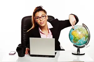 Portable Computer Prints: Businesswoman pointing to a world globe