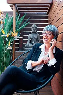 Human Representation Prints: Businesswoman talking on smart phone in backyard