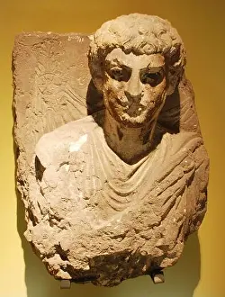Curly Hair Prints: A bust of limestone. The statue represents a man with curly hair
