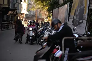 A bustling street in Aizawl, Mizoram, captures the essence of urban life with vehicles and scooters