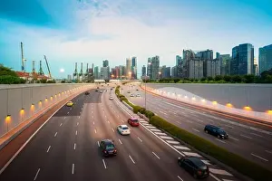 Busy road and city background during rush hour with motion-blurred vehicle, car in Singapore city highway. Singapore tourism, modern city life, or bus