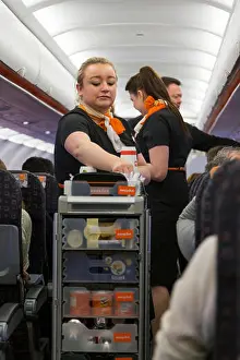 Bring Prints: Cabin crew / air stewardess serves drinks