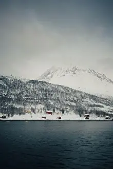 Brim Prints: Cabins by the arctic ocean in the snowy Lyngen Alps in winter in Norway
