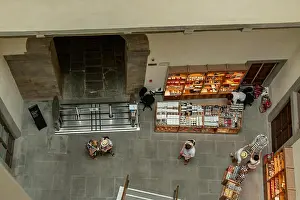 Browsing Prints: A cafe inside the Uffizi from above with tourists browsing the products on sale