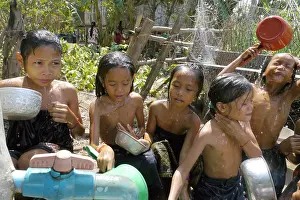 Cambodia Children washing at well, Stung Treng