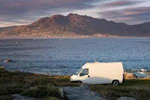 Camper van motorhome with solar panels view on a sea landscape with mountains living van life in Galiza, Spain