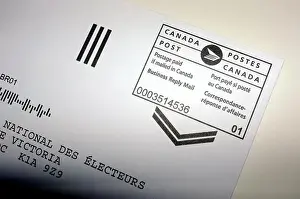 A Canada Post postage paid stamp on a letter photographed against a white background