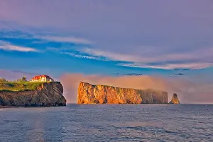 Perce Prints: Canada, Quebec, Perce. House on cliff and Perce Rock in Atlantic Ocean