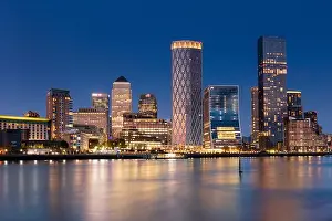 Flowing Water Prints: Canary Wharf skyline reflecting in the River Thames at dusk