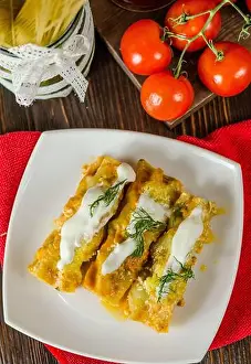 Casserole Prints: Cannelloni with meat filling in a cream sauce on a plate