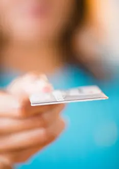Ethnicity Prints: Cape Verdean woman holding out credit card