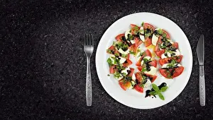 Slate Prints: Caprese salad dish on granite countertop with copyspace on side. Top view