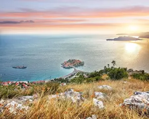 Captivating sunset view of Adriatic coast and islet Sveti Stefan from church st