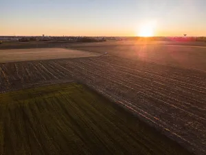 Dirt Road Prints: A car crossing a country road, off-road aerial view of a car traveling a dirt road through the fields