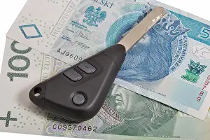 Rent Prints: Car keys on Polish zloty banknotes background closeup isolated on white